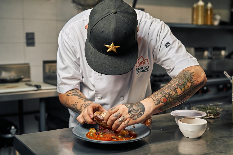 Chef meticulously plating gourmet food for an event